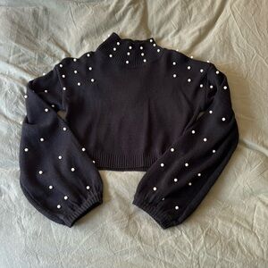 Black sweater with pearl detailing. Never worn